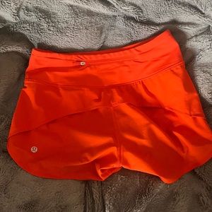 Orange Lululemon Speed up shorts. Mid rise 4” size 2! Rare color no longer sold.